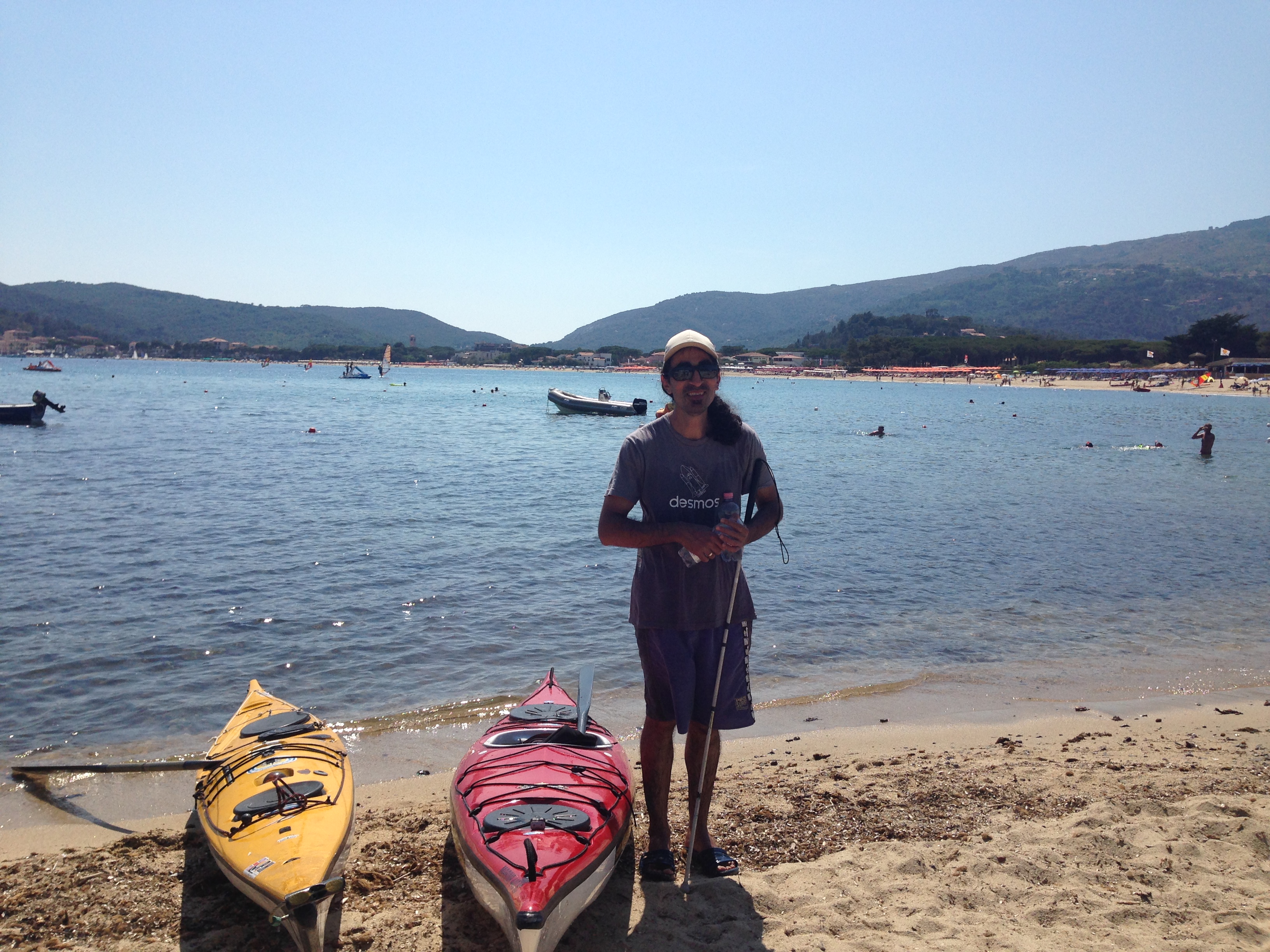 Ahmet is standing between two kayaks